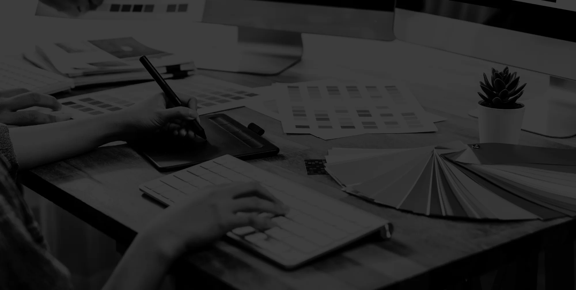 Person working on a design with colour palette, branding and computer